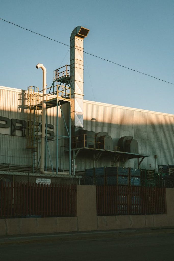 pexels photo 33041458 A factory exterior with large vents and machinery, captured at sunrise, showcasing industrial architecture.